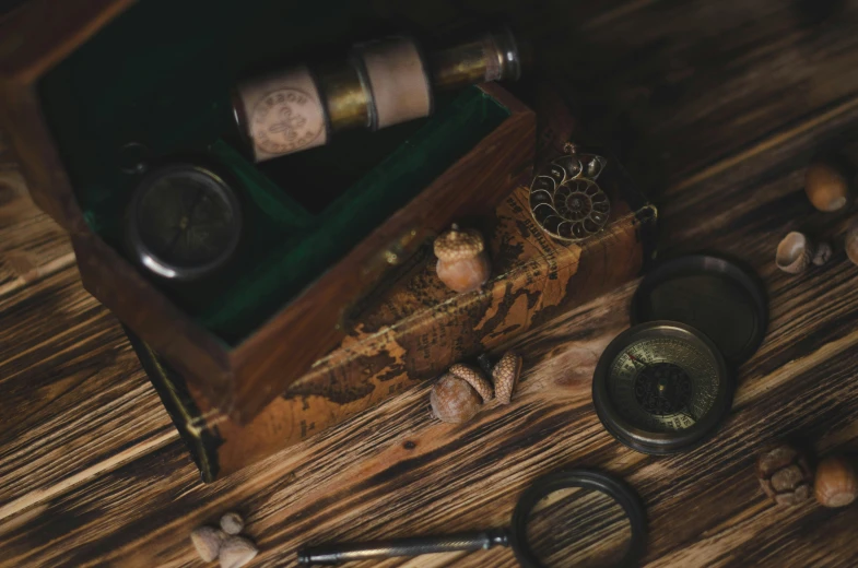 three jars and two corks in a wooden box