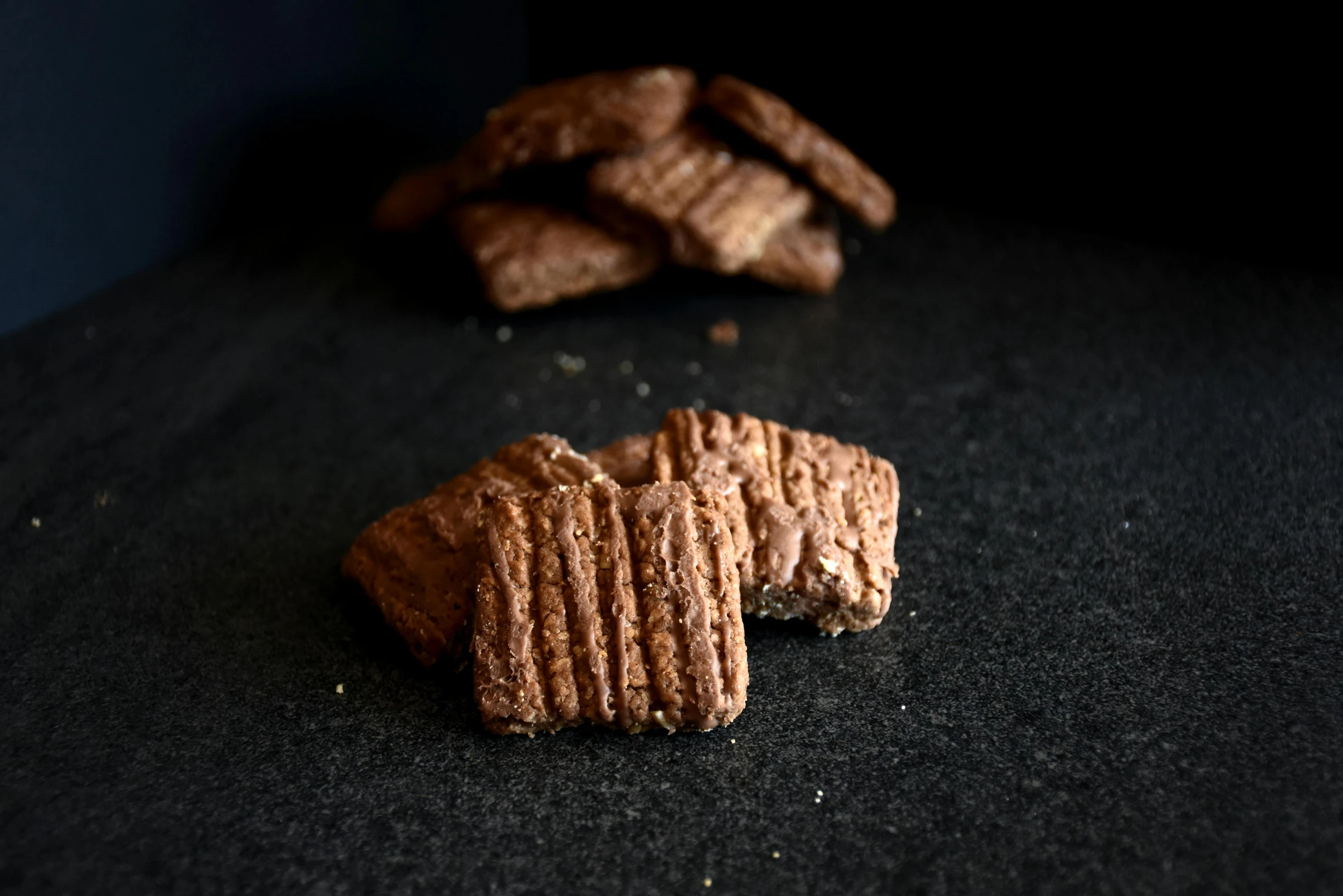 some biscuits are laying on a black surface