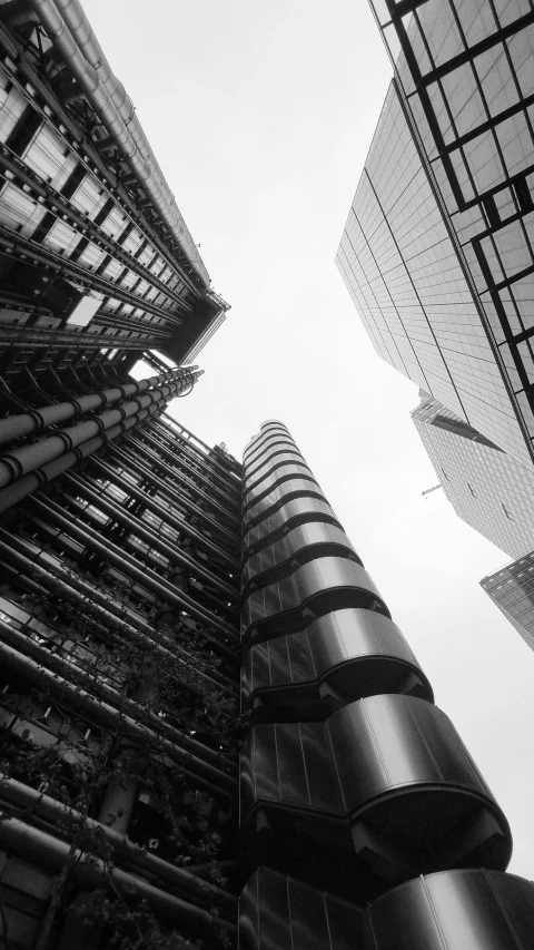 the outside of two tall buildings, looking up