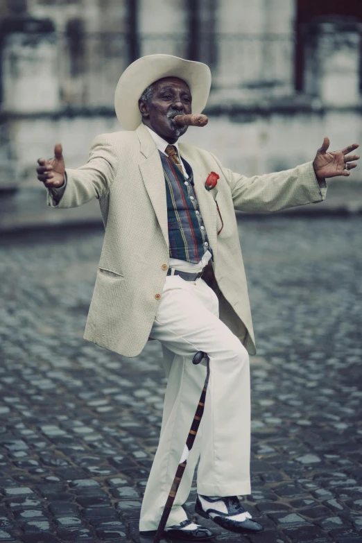 a man with a cigar standing and smoking a cigarette