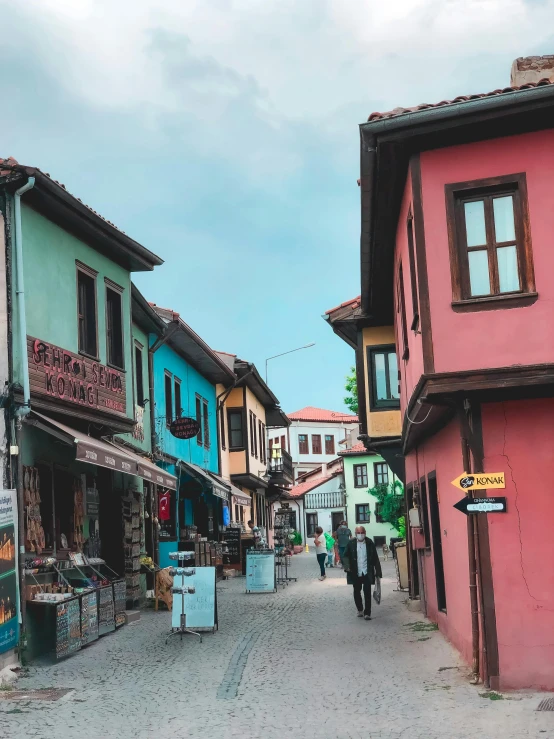 some people walking down a street near several houses