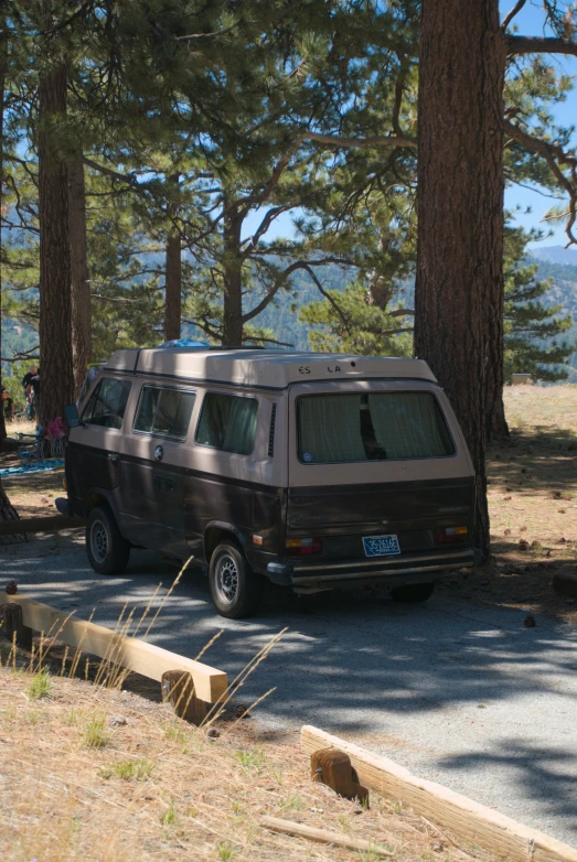 a van with its doors opened sitting in a wooded area