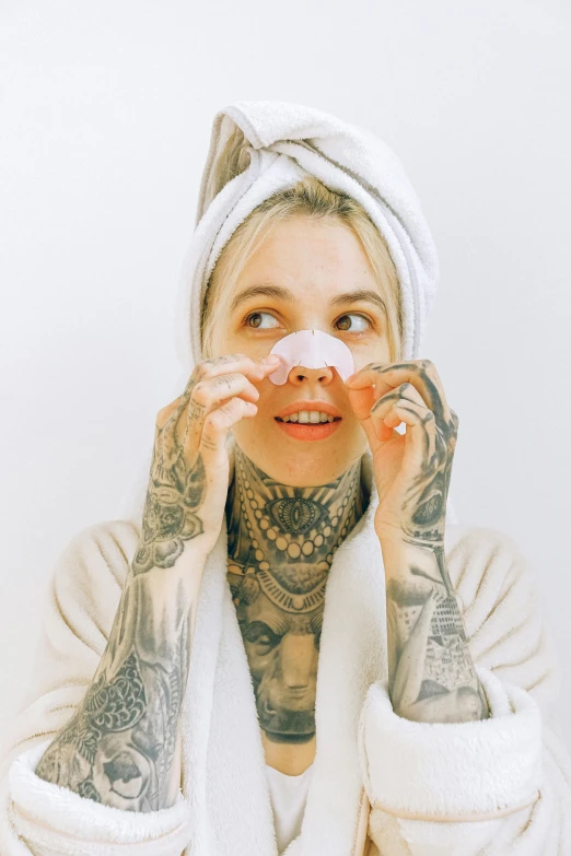 a woman has an on her face with tattoos