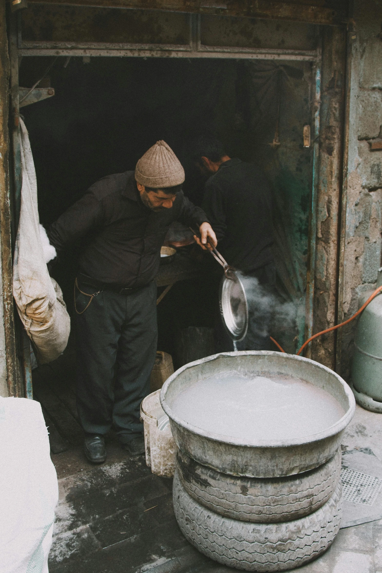 a person holding onto a pan while pouring water