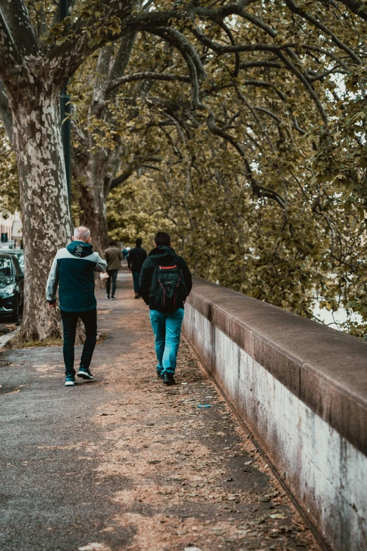 a group of people walking down a road