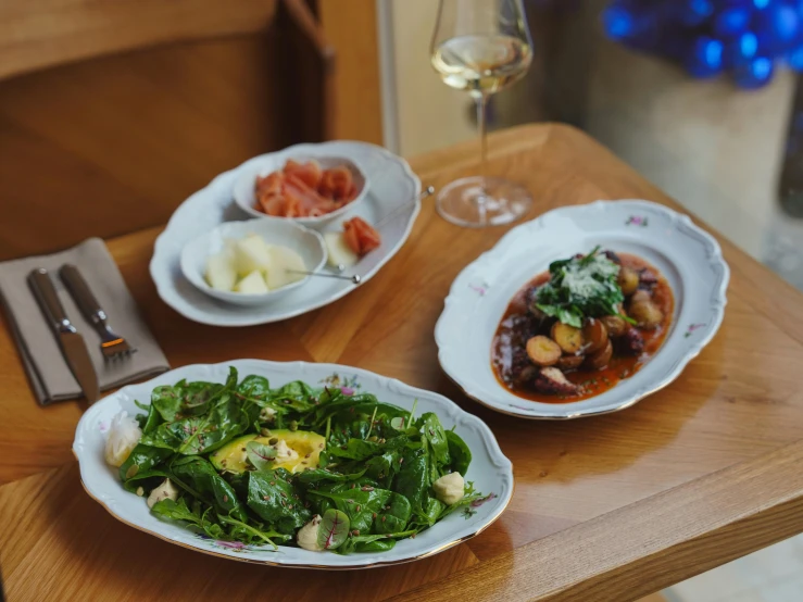 a table with dishes of food and wine