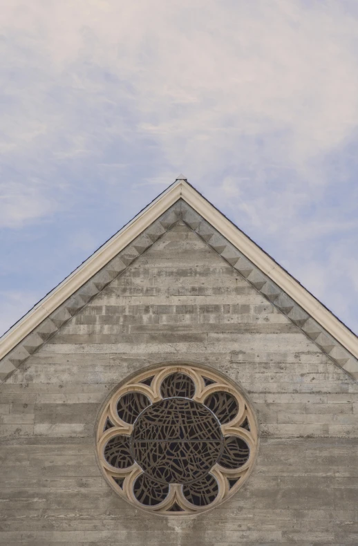 there is a circular window that can be seen above the windows