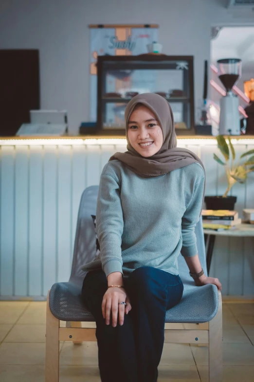 a woman wearing a headscarf sitting on a bench