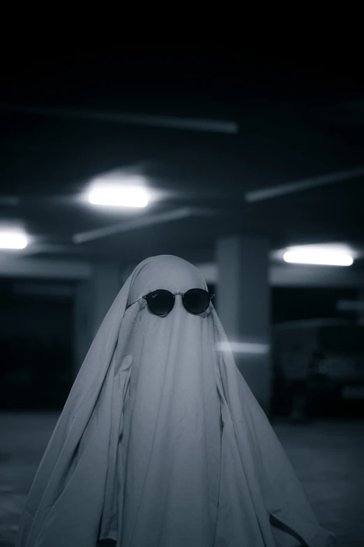 a ghost in glasses standing in a parking garage