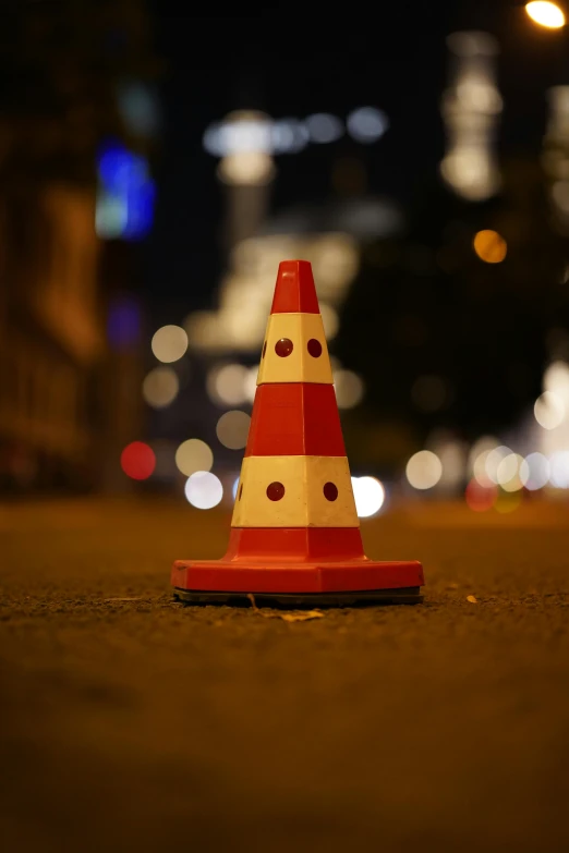 a traffic cone on a city street at night