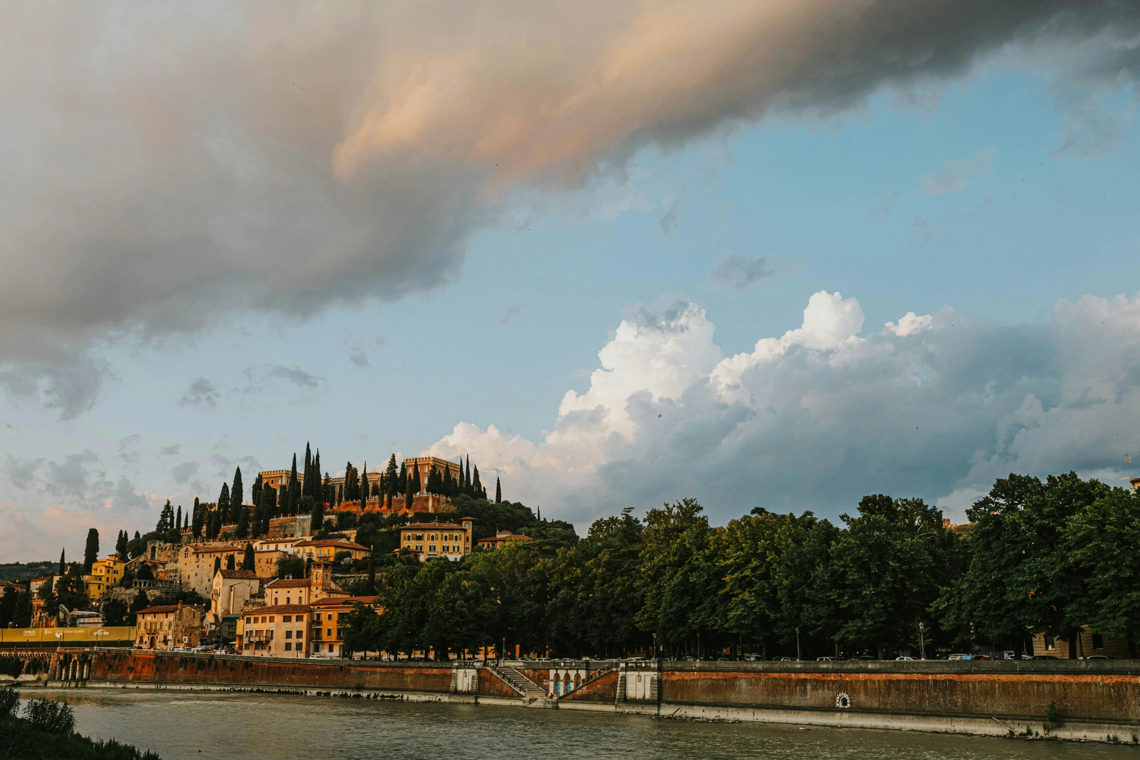 a castle on a hill next to a body of water