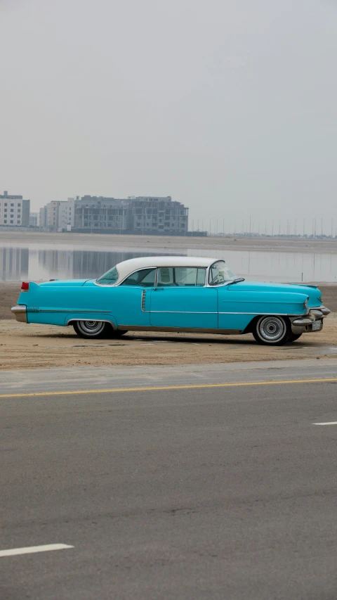 a blue and white car parked on a field