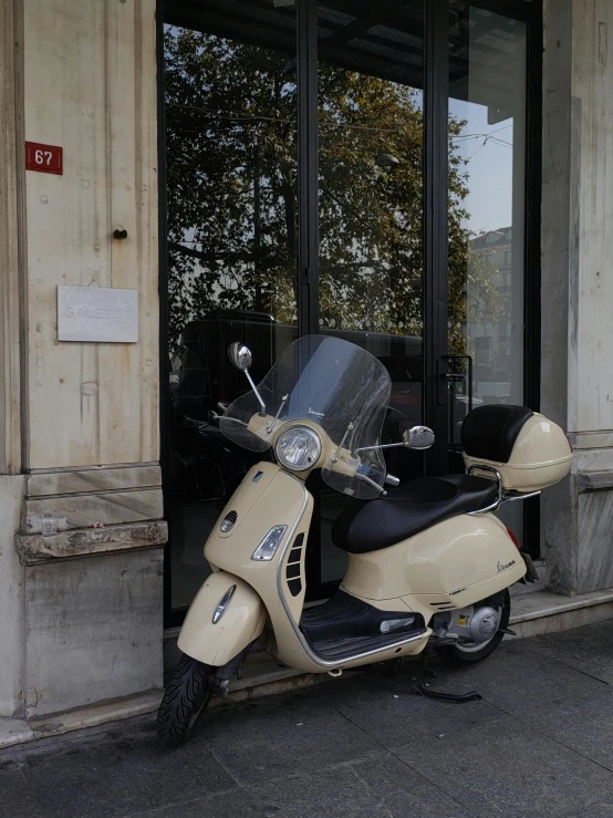 the scooter is parked in front of the building