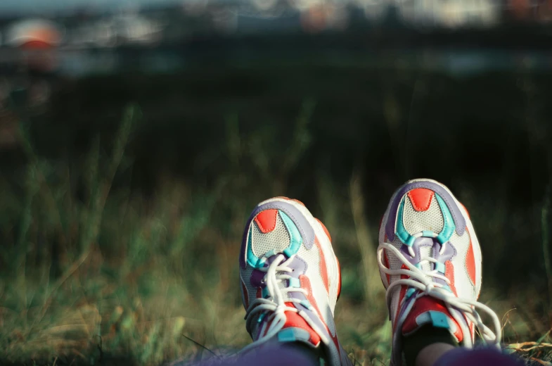 someone's shoes standing in a field, looking at the camera