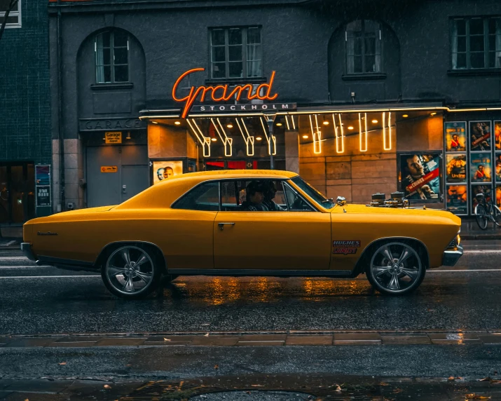 a yellow car sitting in front of a store