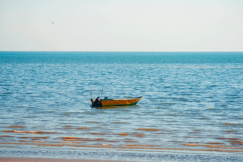 a small boat on the water on a sunny day