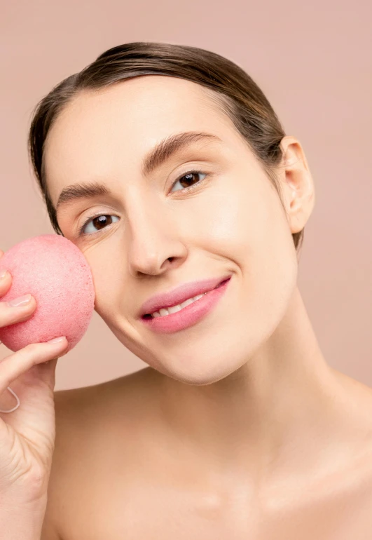 the woman is holding a ball up to her face