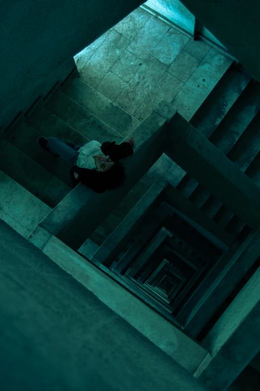 the man is lying down on the stairs