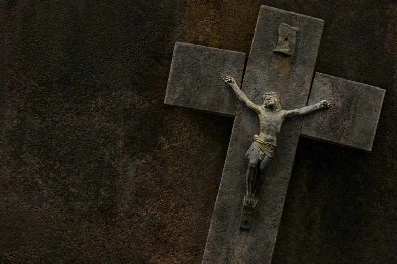 a crucifix is shown on the cement with gold paint