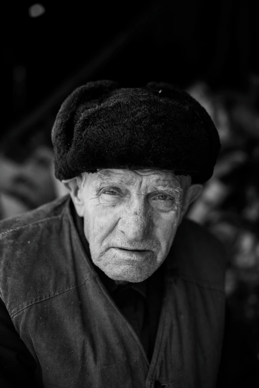 an older man sitting on top of a wooden bench