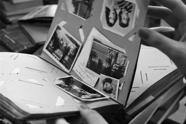 a person holds up a book in order to see the pages