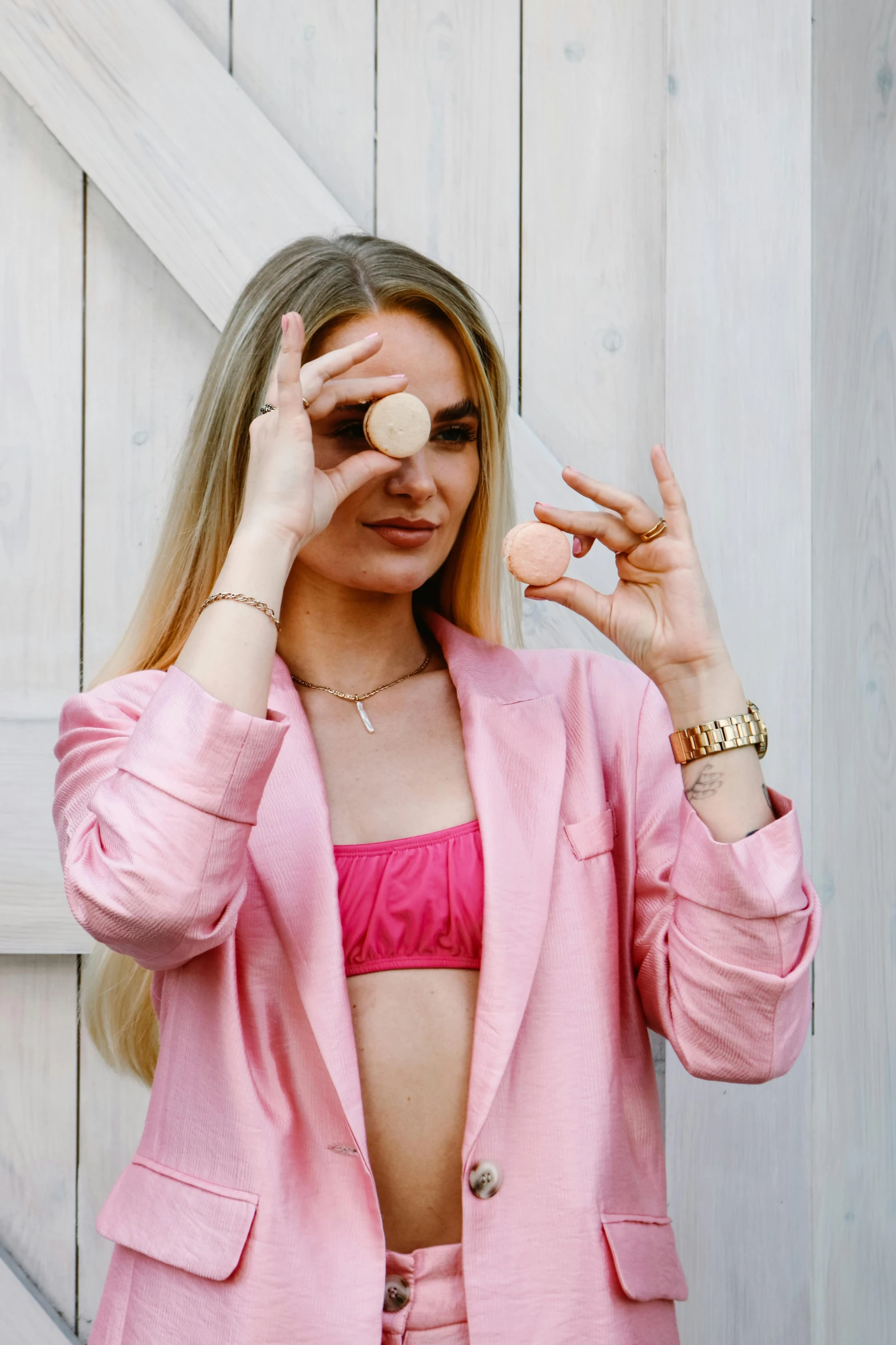 a woman in a pink bikini holding her hands to her forehead