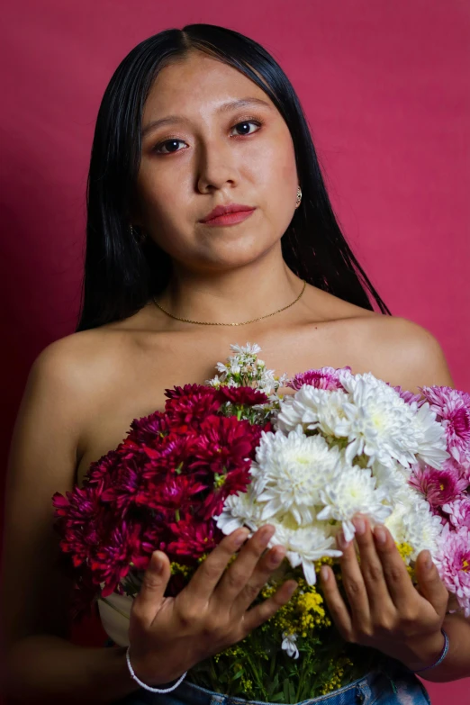 a girl holding onto a bouquet of flowers