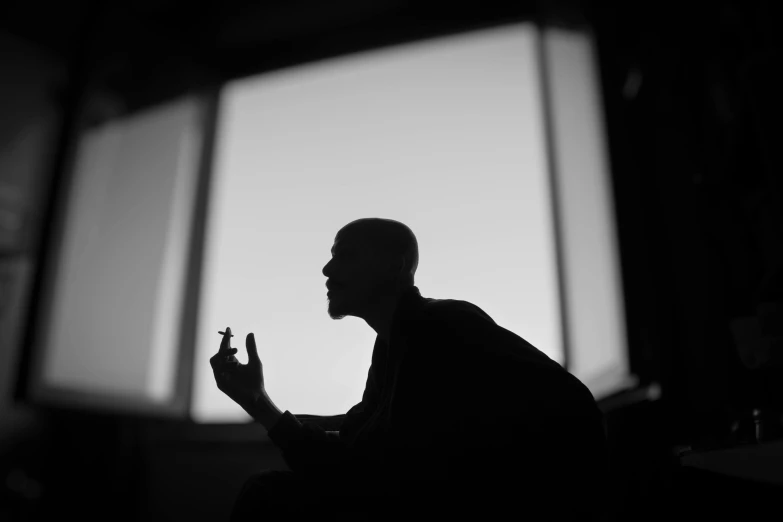 a man sitting on the floor with a cellphone