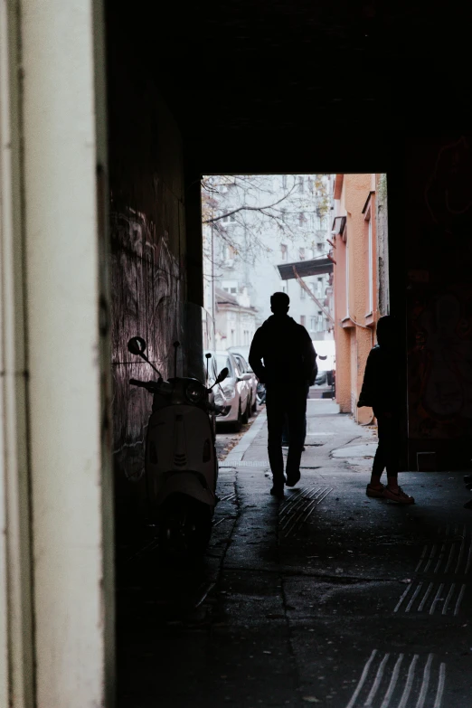 people walking along side walk in narrow area