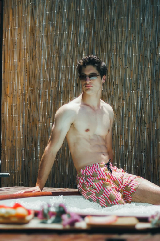 the man is posing for a picture while sitting in a pool