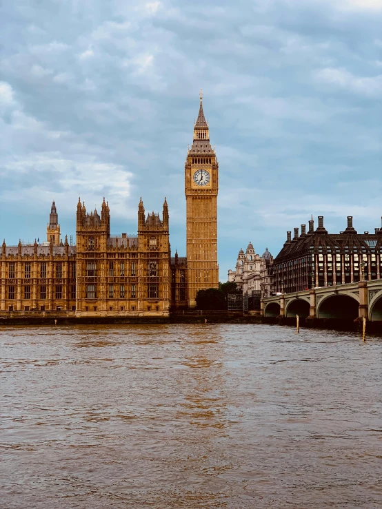 an old building and clock tower overlooking water