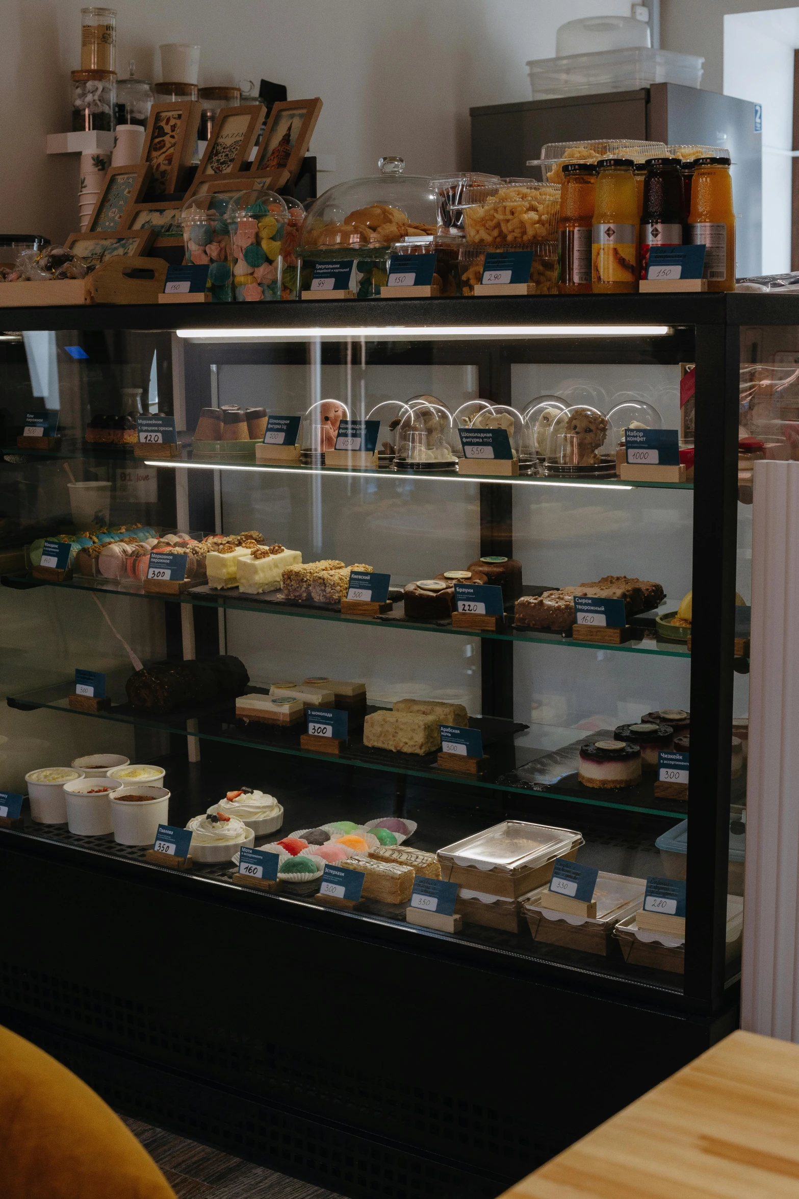 a glass front filled with cakes and baked goods