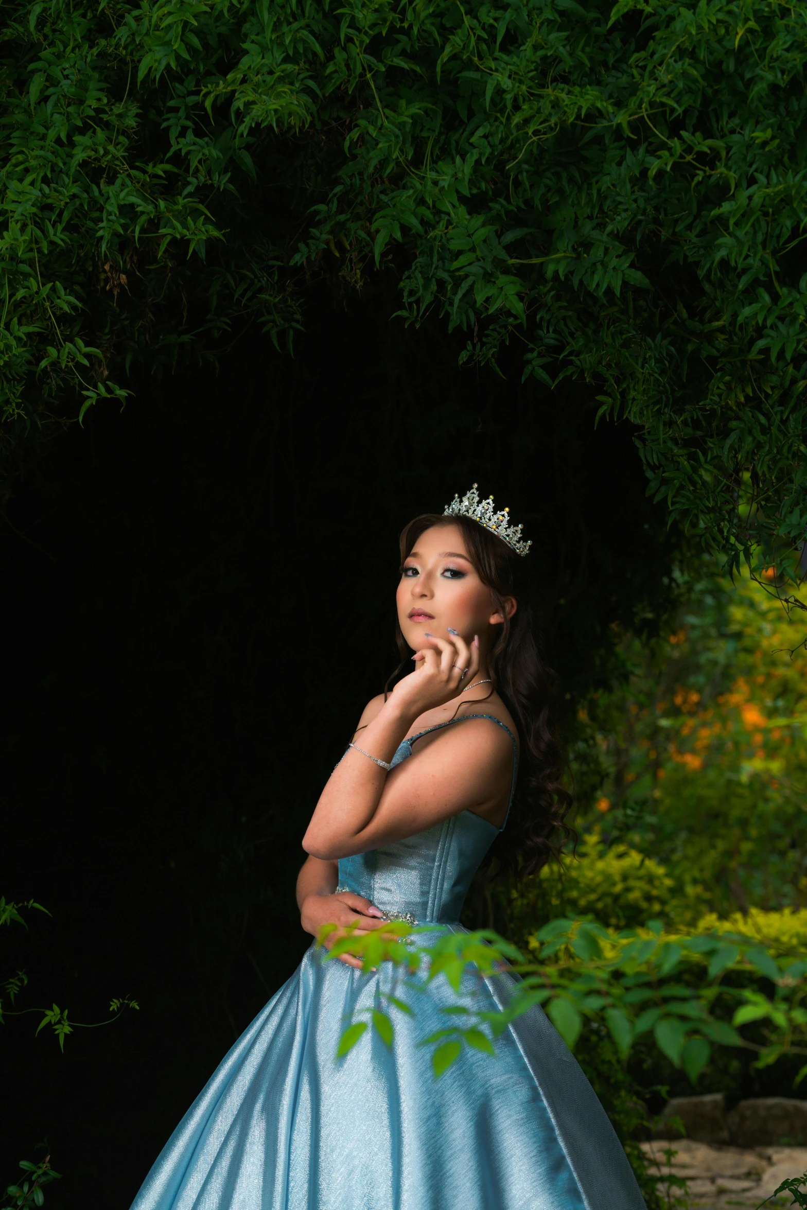 a woman in a blue dress is looking into the distance