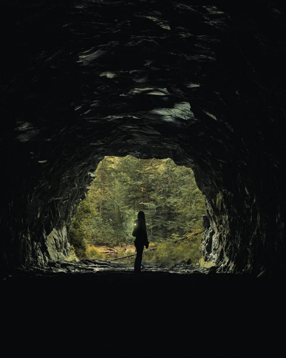 a man standing in the middle of a large tunnel