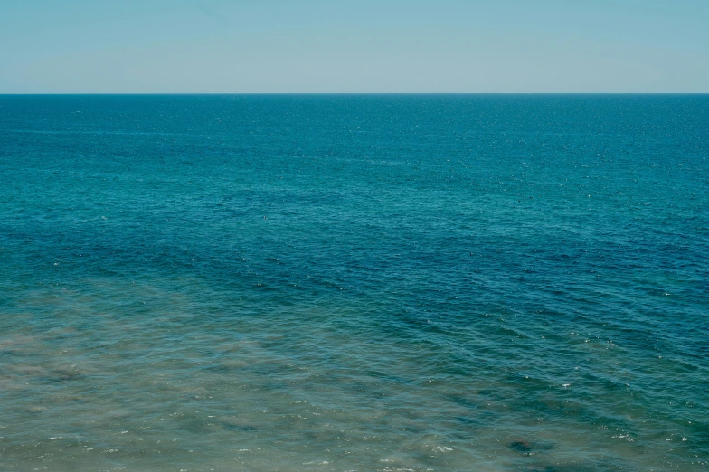 a lonely boat on a wide open blue ocean