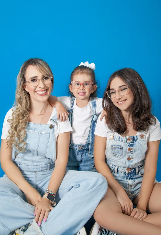 two girls and one girl sitting on the floor