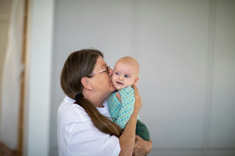 a woman holds a baby in her arms