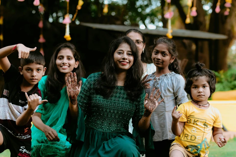 young children posing for a group picture with their mother