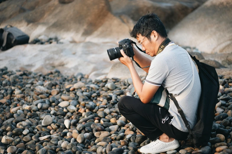 a pographer squatting down to take a po