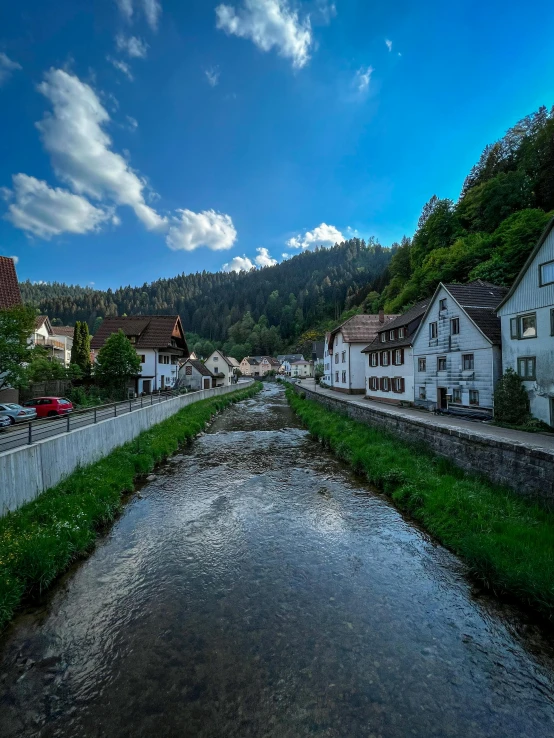 a small town by the river has houses and cars