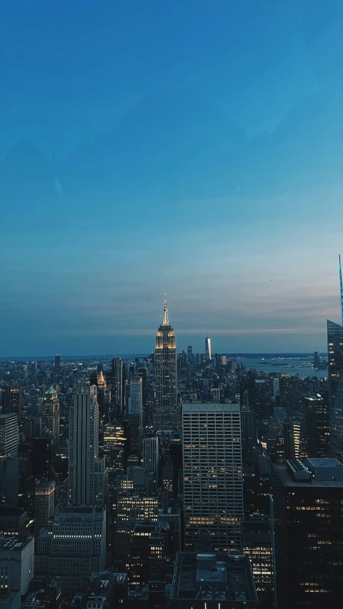 aerial view of several large city buildings on a bright, sunny evening