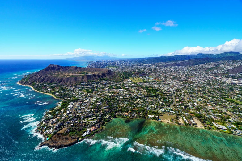 a town and a beach on an island with clear blue waters