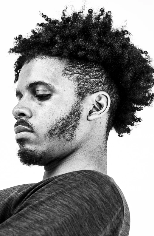 a man with an afro stares intently into the distance