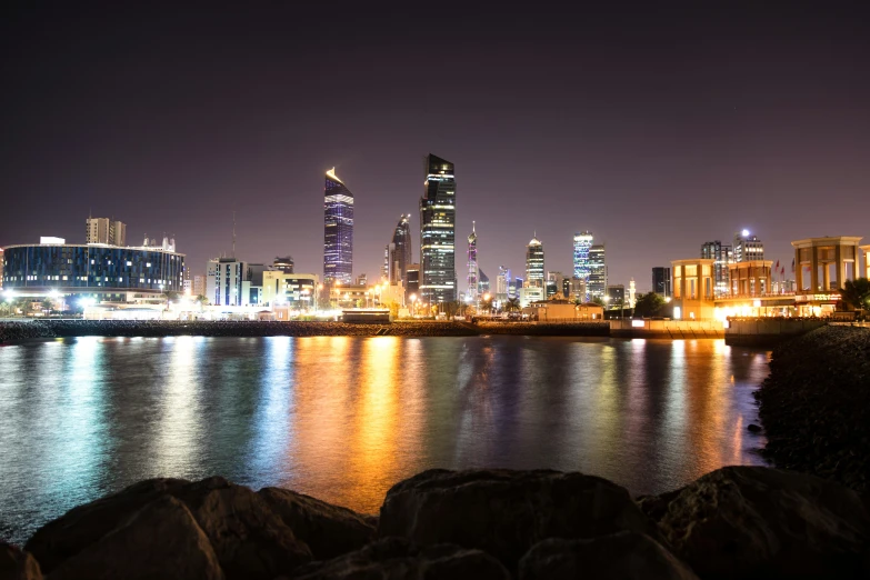 a city at night with lights reflected in the water