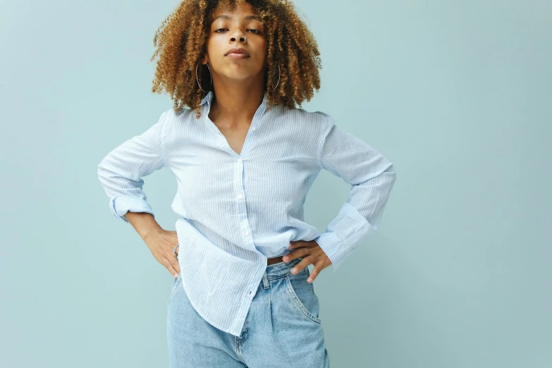 a woman poses with her hands on her hips