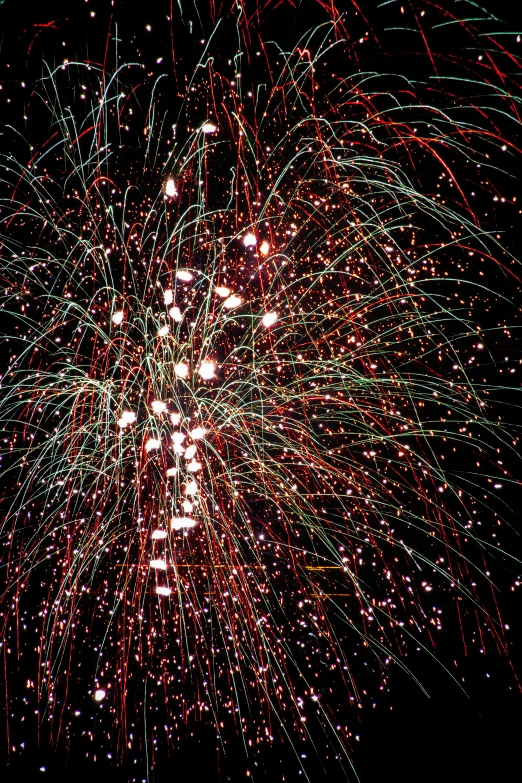 a very bright colorful fireworks on a dark night sky