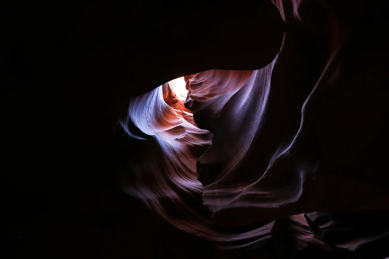 a large narrow opening to light in the middle of a canyon