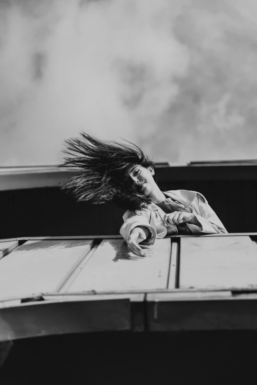 a woman sitting on top of a wooden platform