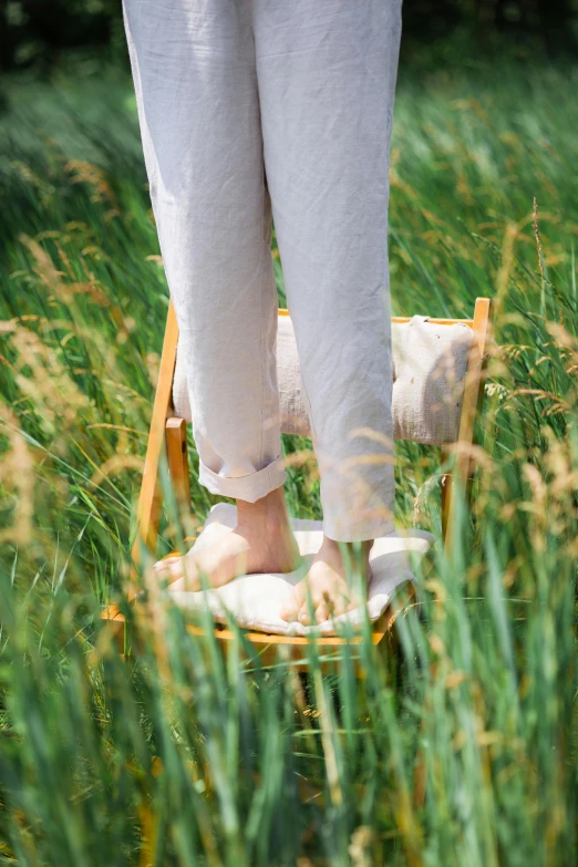 the feet of someone in slippers are standing on a chair