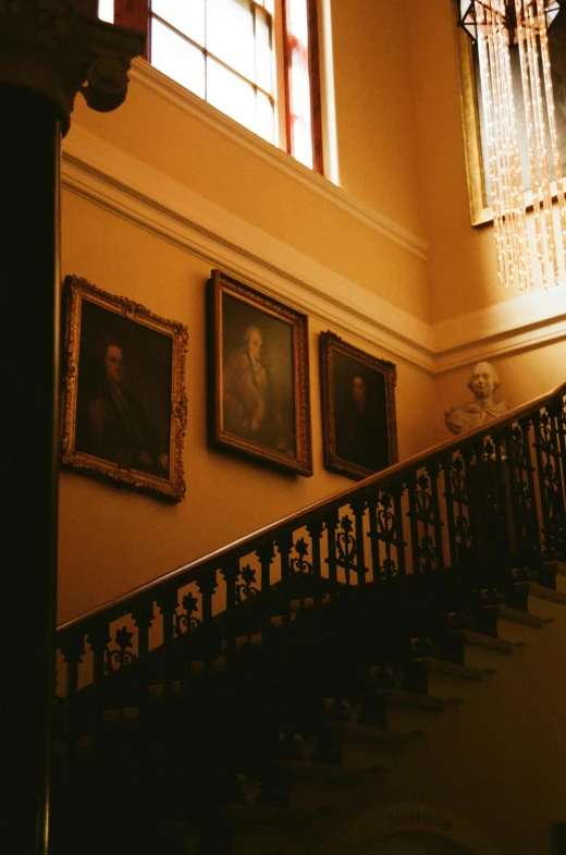 a stairway with paintings on the wall